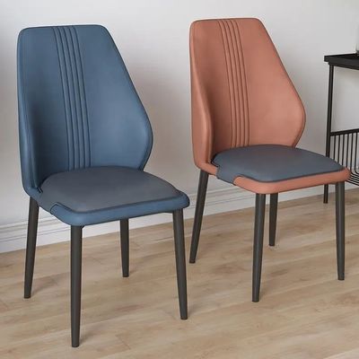 Sillones de comedor tapizados a medida Sillón de comedor tapizado de cuero interior naranja